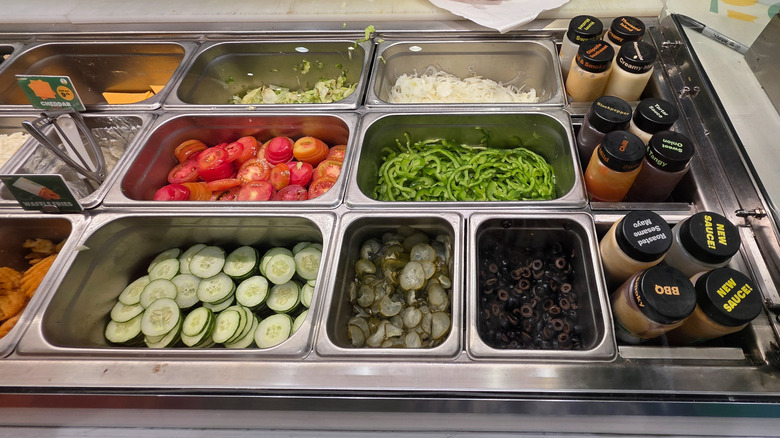 Variety of vegetables behind the glass of a Subway