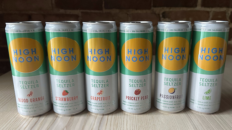 Cans of High Noon tequila seltzer on wooden table