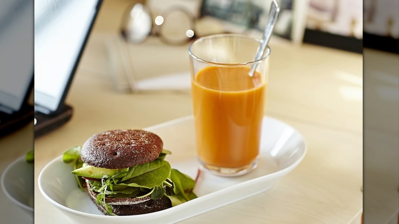 Ikea 365+ glass with juice on a platter with a veggie sandwich