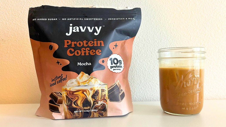 Bag of Javvy mocha coffee mix next to kerr jar of coffee on white table