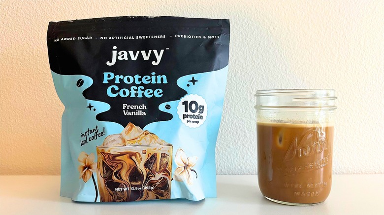 Bag of Javvy French vanilla coffee mix next to kerr jar of coffee on white table