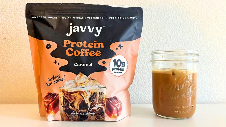 Bag of Javvy caramel coffee mix next to kerr jar of coffee on white table