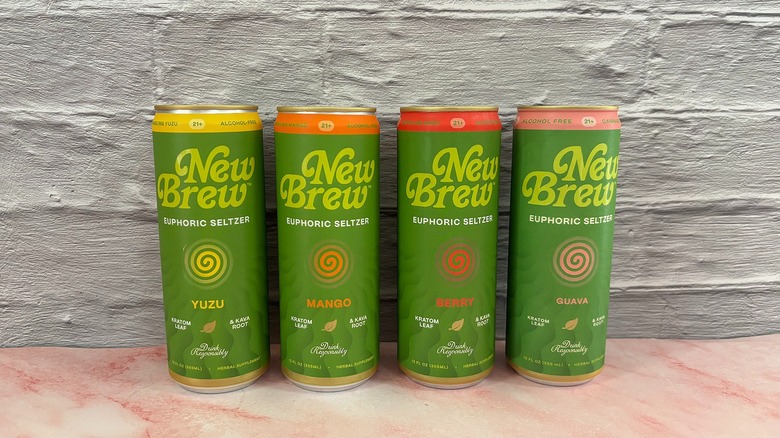 Four New Brew kava seltzer cans on grey background