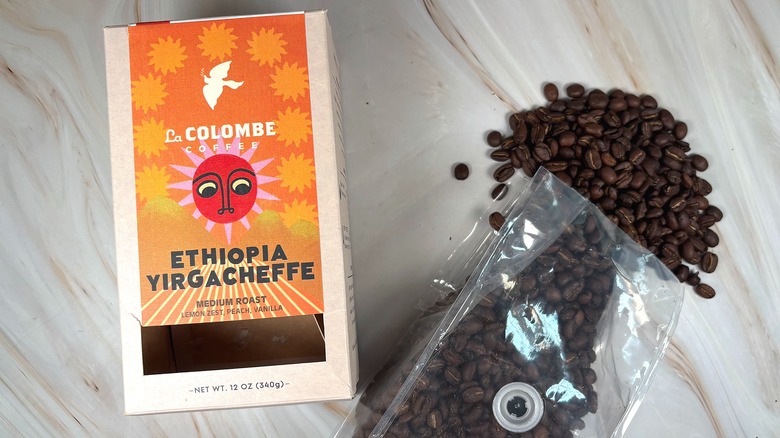 Box of La Colombe Ethiopia Yirgacheffe next to bag of beans spilling out onto table