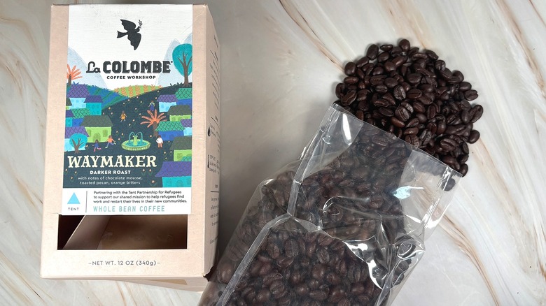 Box of La Colombe Waymaker next to bag of beans spilling out onto table