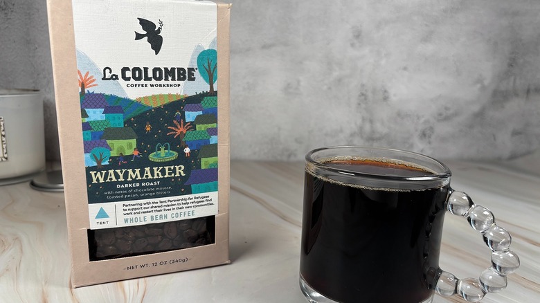 Box of La Colombe Waymaker next to brewed mug of coffee on table