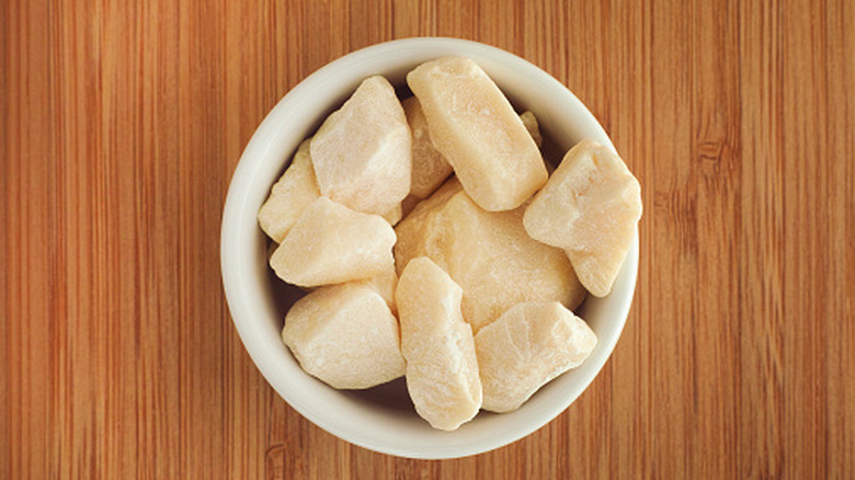 Pieces of cocoa butter in white bowl