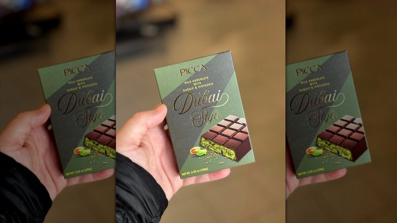 Hand holding Aldi Picca Dubai Style chocolate bar