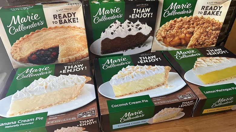 Marie Callender's pie boxes arranged on table with brick background