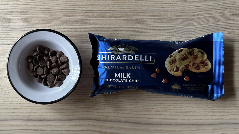 Ghirardelli Milk Chocolate Chips on wooden table
