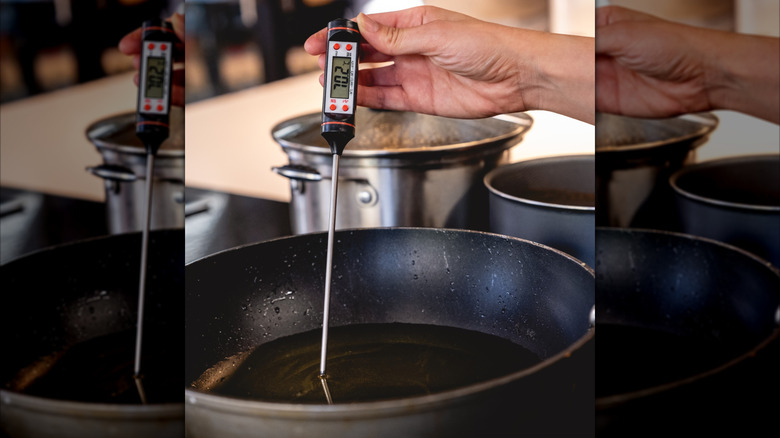 person using digital thermometer to measure oil temperature in skillet