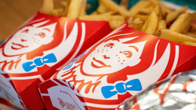 Two cartons of Wendy's fries side by side
