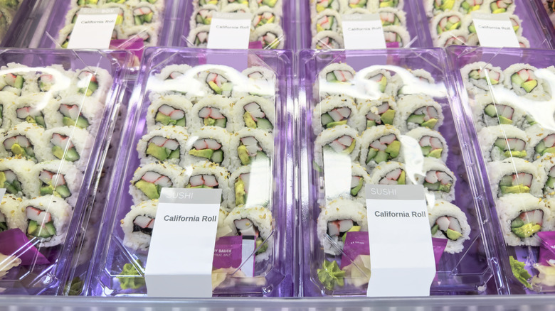 Packages of grocery store sushi arranged in fridge