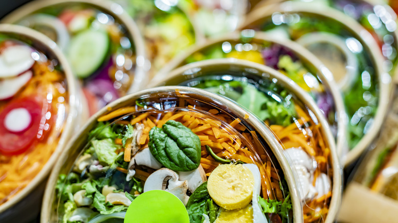 Prepped salads in to-go containers at grocery store
