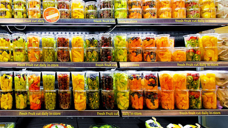 Grocery store prepared foods section with cut fruit