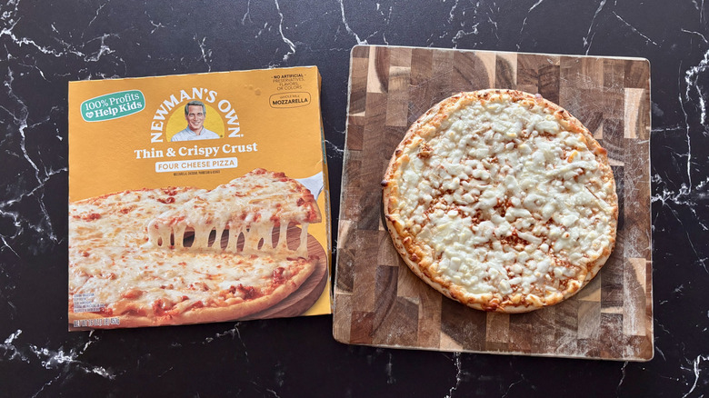 Newman's Own four cheese pizza box next to cheese pizza