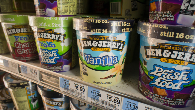 Various flavors of Ben & Jerry's pints in a shop freezer.