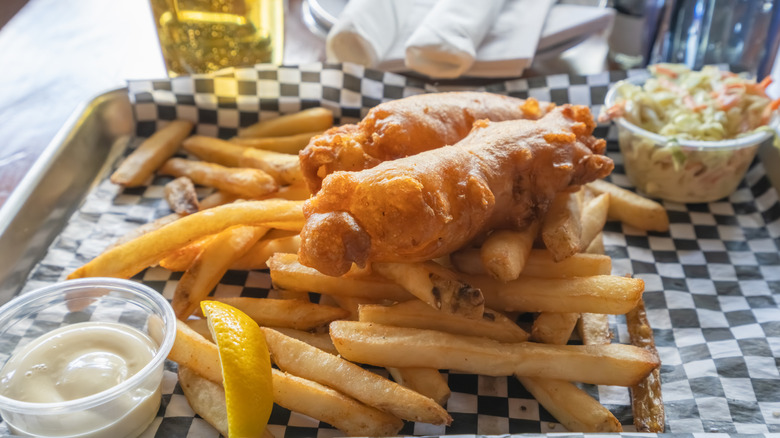 fish and chips plated with coleslaw and tartar sauce