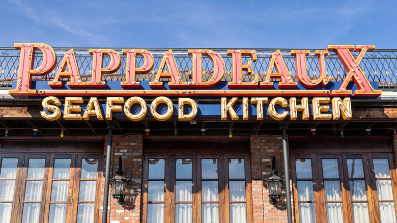 Exterior sign for Pappadeaux Seafood Kitchen against blue sky