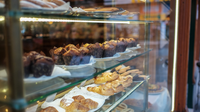 A variety of plated pastries behind a glass wall