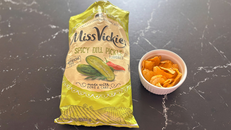 Miss Vickie's spicy dill pickle chip bag next to chips in bowl