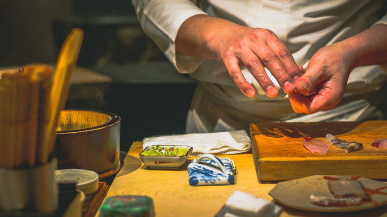 Sushi chef preparing omakase at a restaurant counter