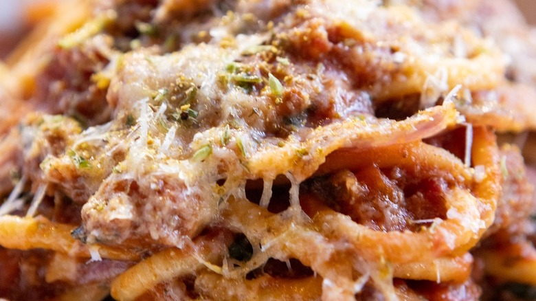 Closeup of crushed meatballs and spaghetti with cheese from North Italia