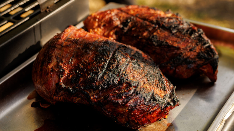 Grilled beef brisket resting on a metal tray