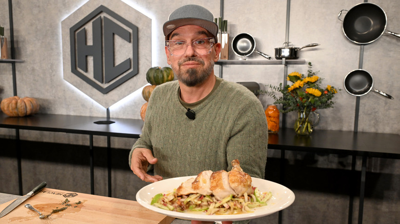 Chef Michael Symon serving up a plate of sliced turkey