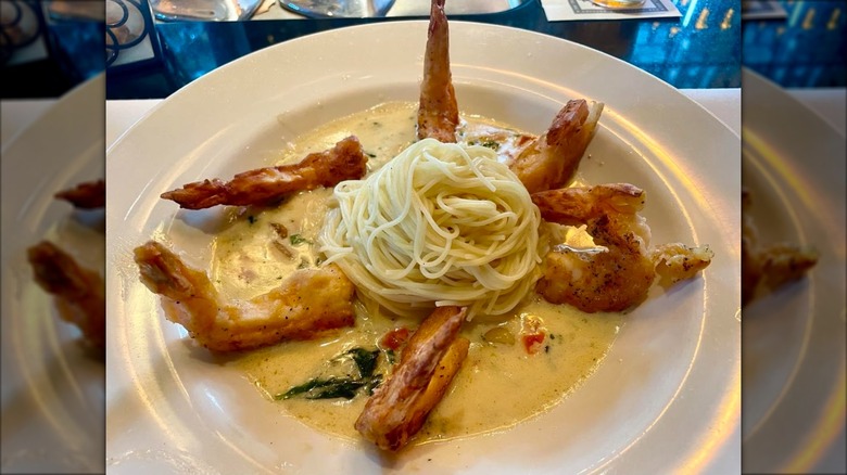 Plate of shrimp scampi in a white sauce with standing shrimp
