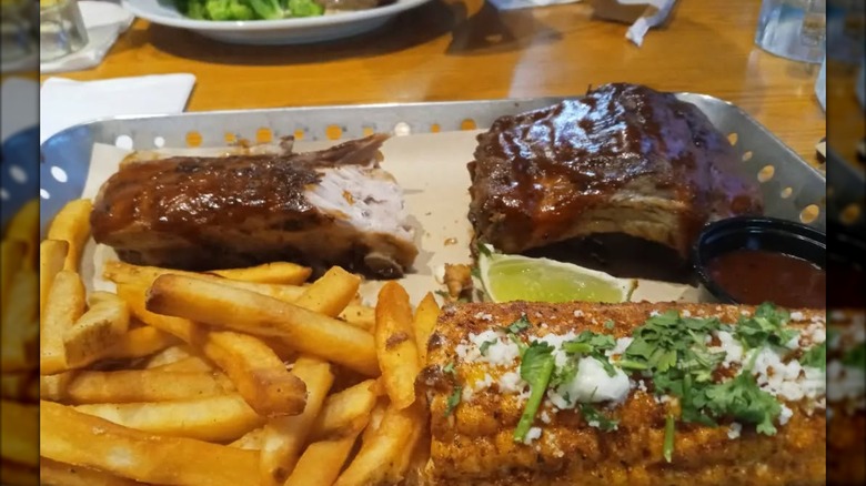 Tray of Chili's ribs, fries and corn on the cob