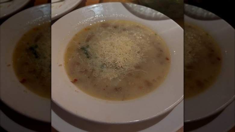 Bowl of Zuppa Toscana topped with shredded cheese