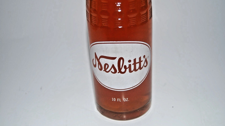 Close up of Nesbitt's bottle against grey background