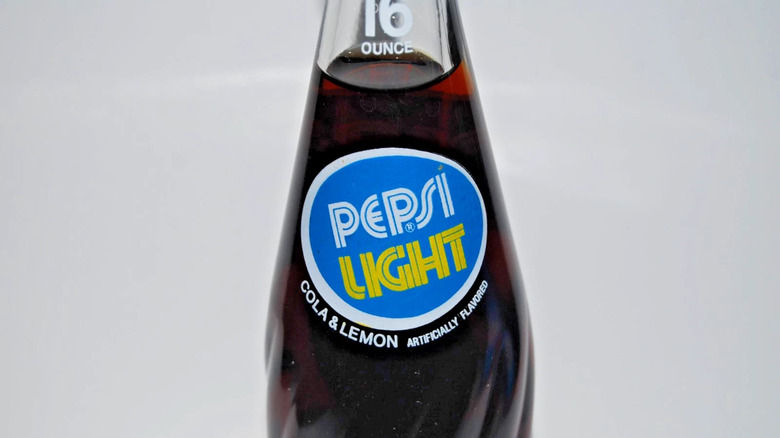 Close up of Pepsi Light glass bottle against grey background