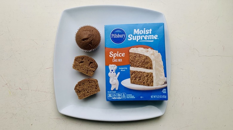 box of Pillsbury Moist Supreme Spice Cake Mix on a plate with baked cupcakes