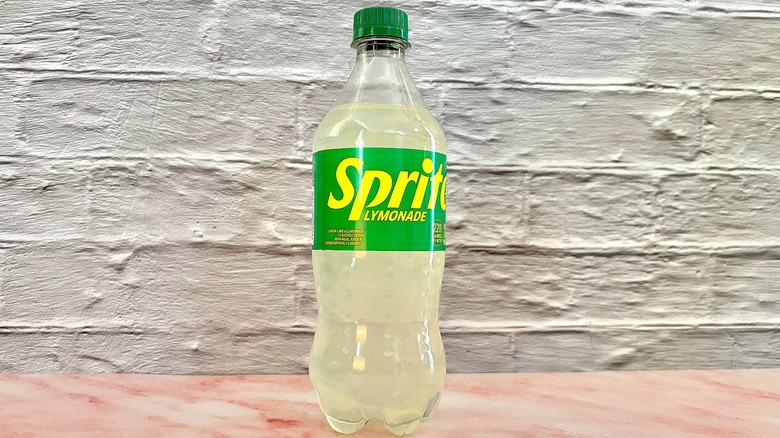 Bottle of Sprite lymonade on pink marble surface