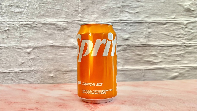 Can of sprite tropical mix on pink marble surface