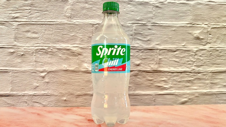 Bottle of Sprite chill cherry lime on pink marble surface