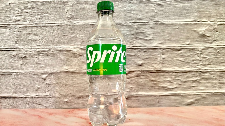 Bottle of Sprite lemon-lime on pink marble surface