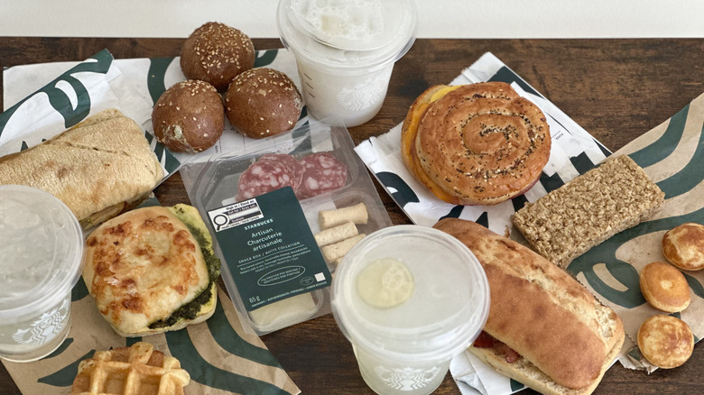Overhead image of wooden table with assorted Starbucks items