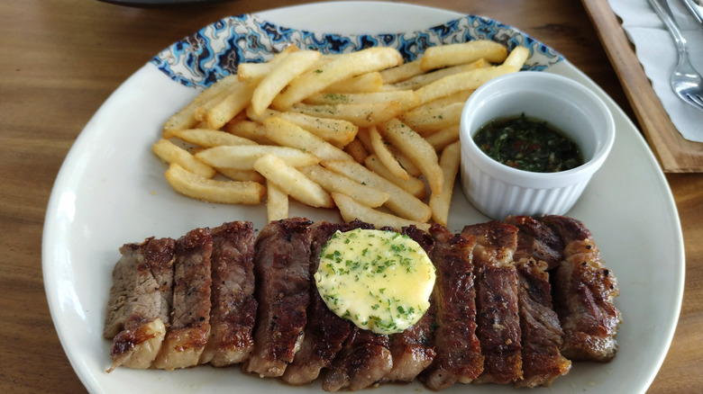 Flank steak plated with fries