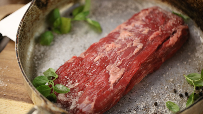Flap steak cooking in pan