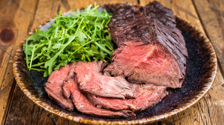 Sliced hanger steak on plate