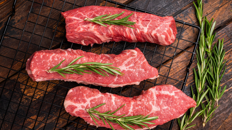 Raw tri-tip steak on cutting board