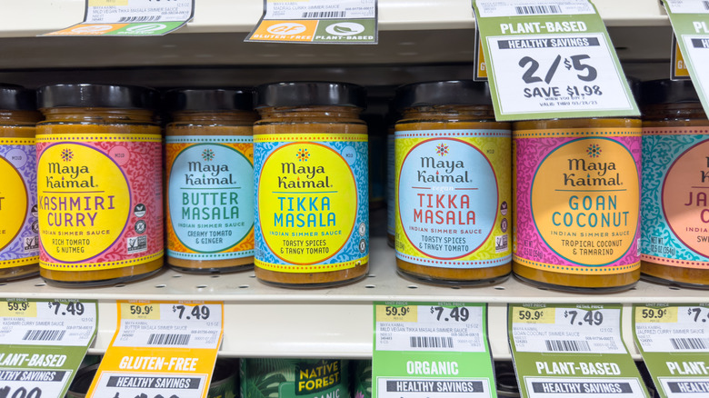 Wide selection of Maya Kaimal simmer sauces on a grocery store shelf