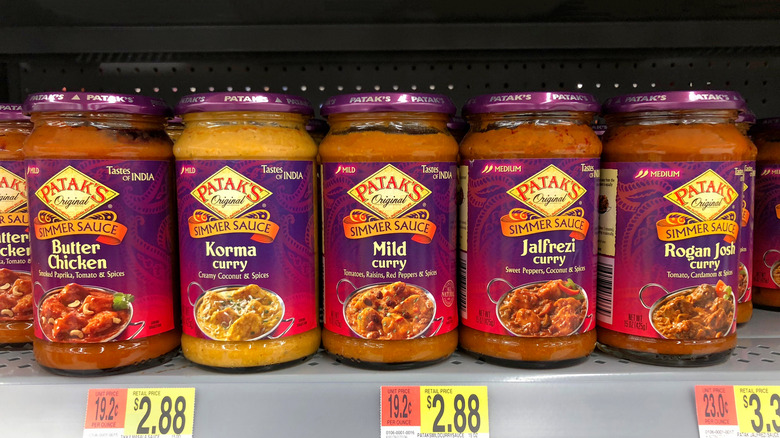 Five varieties of Patak's simmer sauces on a grocery store shelf