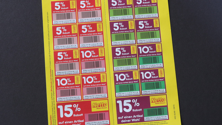A yellow sheet of paper with an array of colorful coupons offering discounts from 5 to 15%.