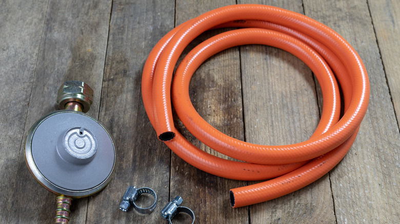 Regulator and hose assembly for gas grill.