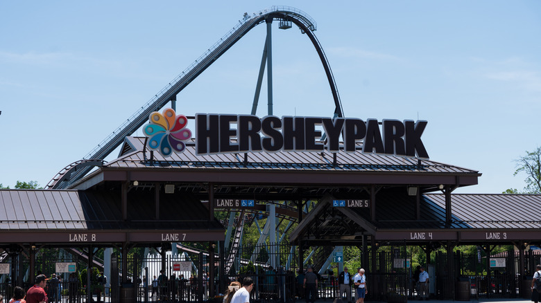 Exterior of Hersheypark with sign, roller coaster in background