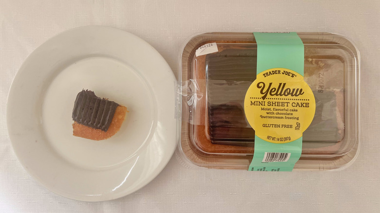 Slice of yellow mini sheet cake with chocolate frosting on a plate